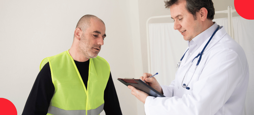 A doctor with a clipboard speaking to a worker wearing a neon yellow safety vest.