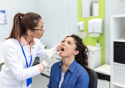 Person touching their sore throat with discomfort from possible strep infection