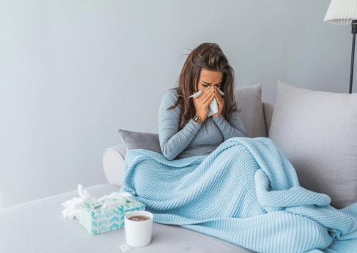 Person experiencing cold and cough symptoms during winter season